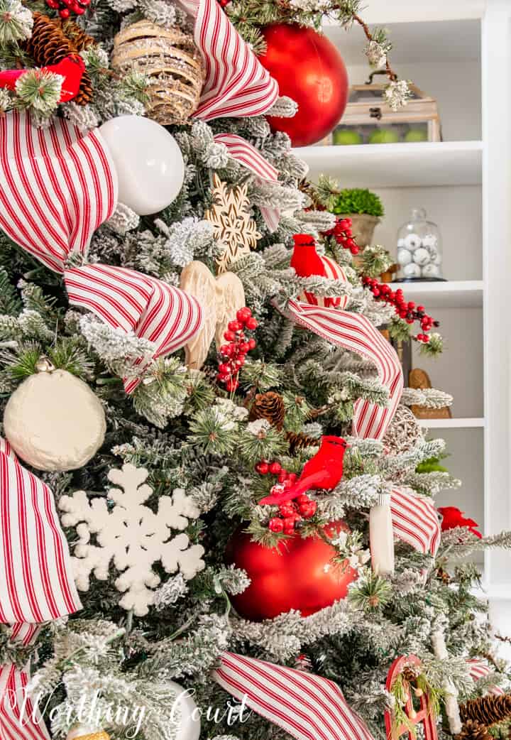 partial view of Christmas tree with red and white decorations