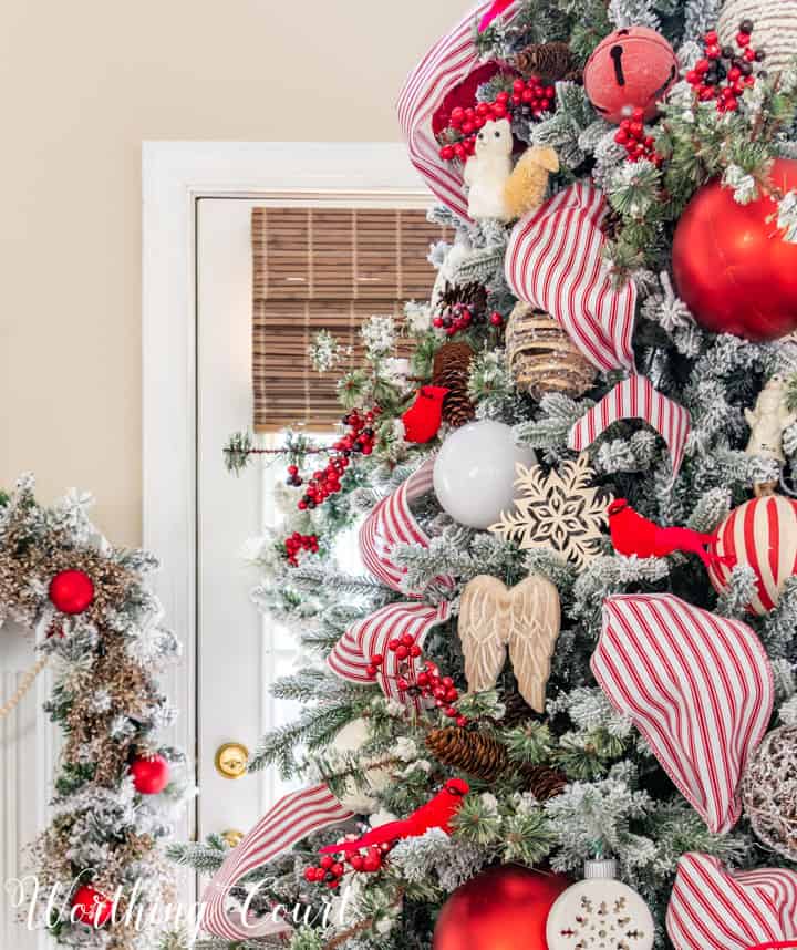 partial view of Christmas tree with red and white decorations