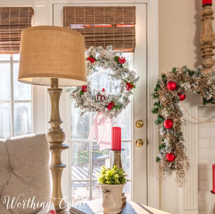 French door with flocked wreath hanging on it