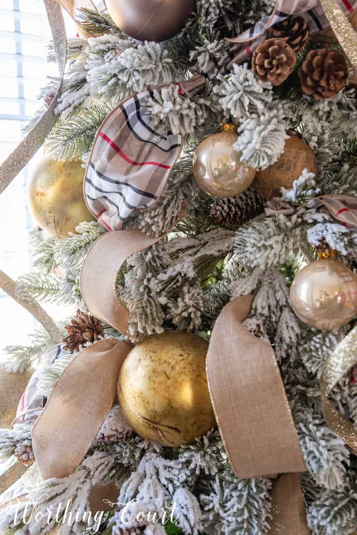 Flocked Christmas tree decorated with gold and neutral colors