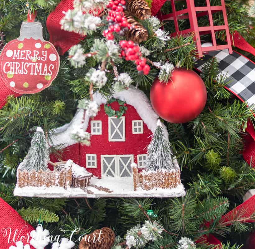 red cardboard house displayed on a Christmas tree
