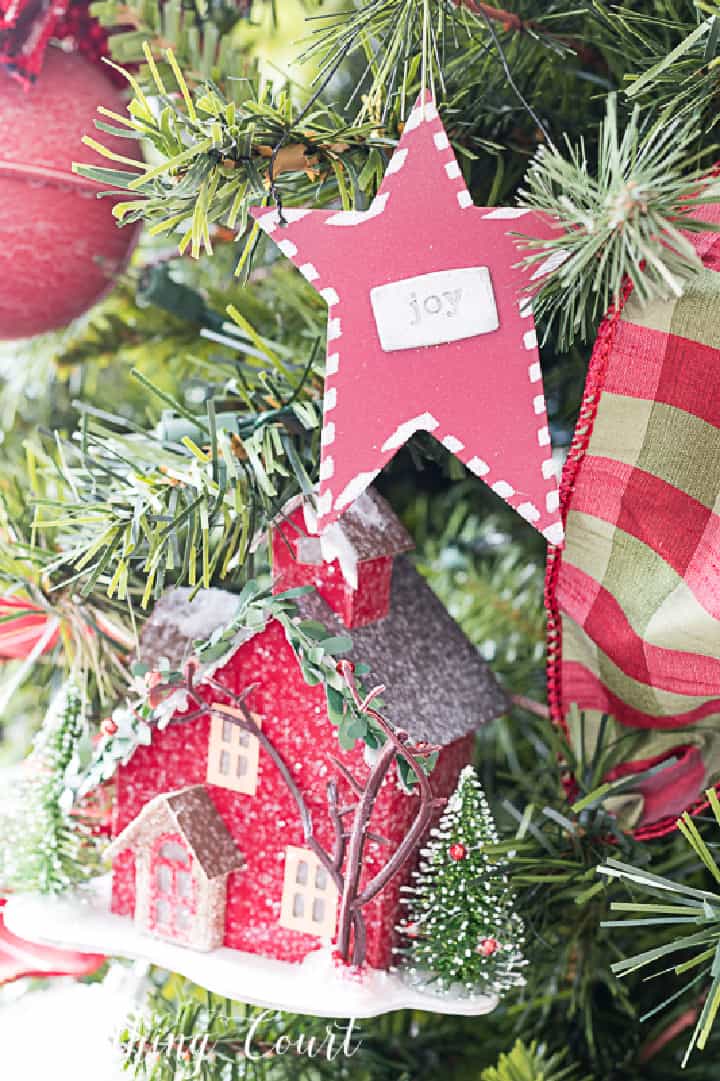 red and green ornaments and ribbon on a Christmas tree