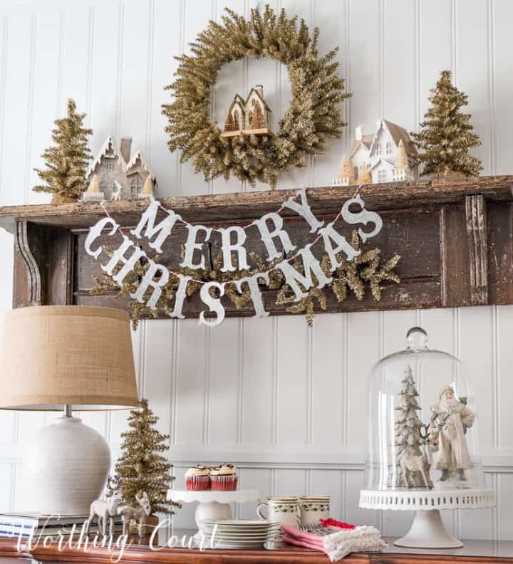 Christmas display with neutral colors on shelf and on sideboard