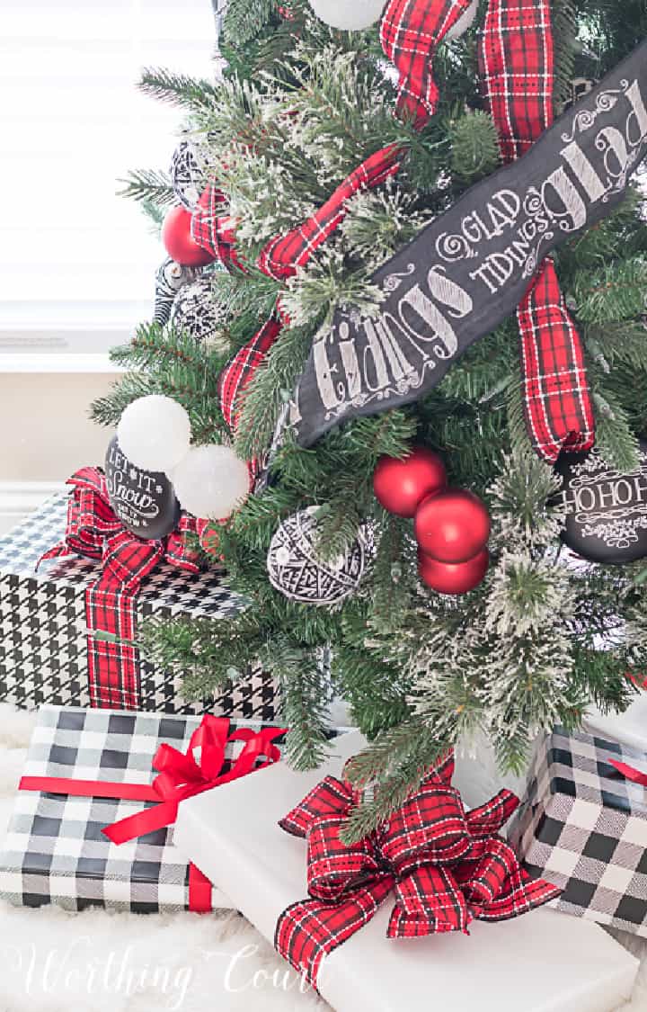 Christmas tree decorated with red, black and white ornaments and ribbon