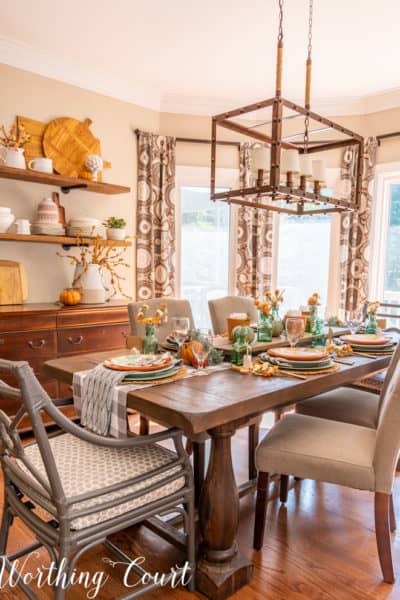 dining room with open shelves and table set for Thanksgiving