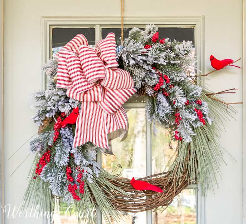 Christmas wreath with faux greenery, cardinals and red and white bow