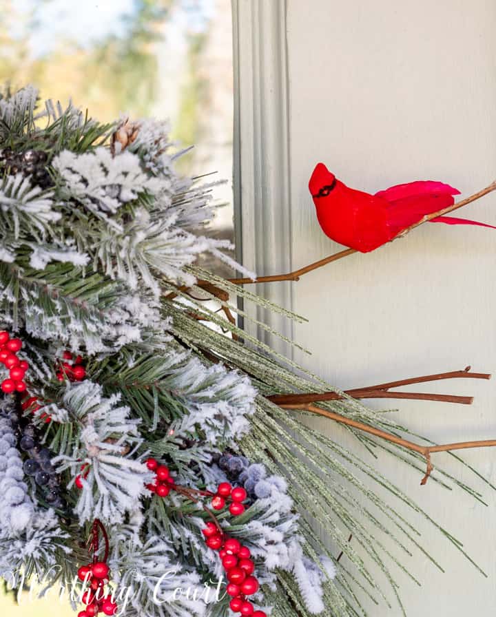 faux cardinal on a branch in a Christmas wreath