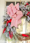 Christmas wreath with faux greenery, cardinals and red and white bow