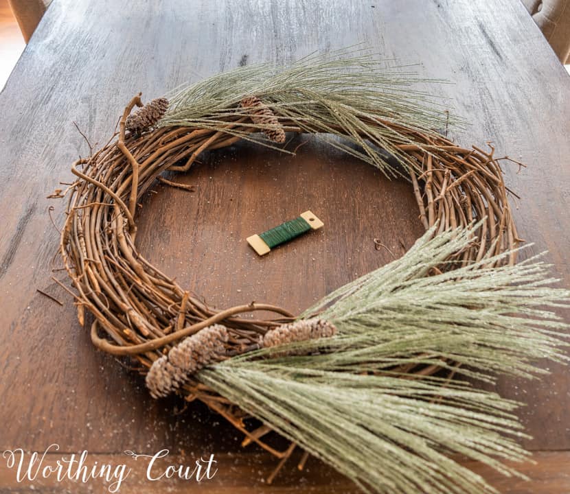 partially assembled Christmas wreath lying on a table