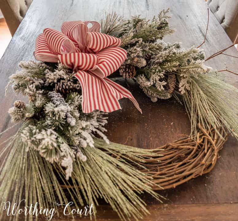 partially assembled Christmas wreath lying on a table