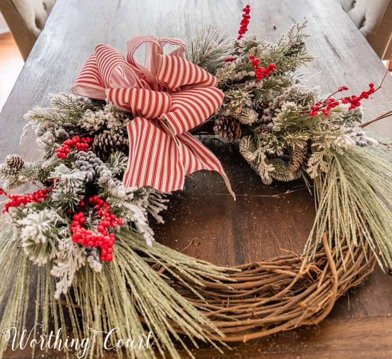 partially assembled Christmas wreath lying on a table