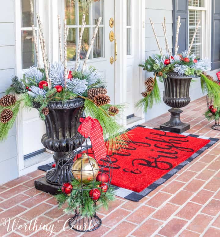 black urns filled with faux greenery for Christmas