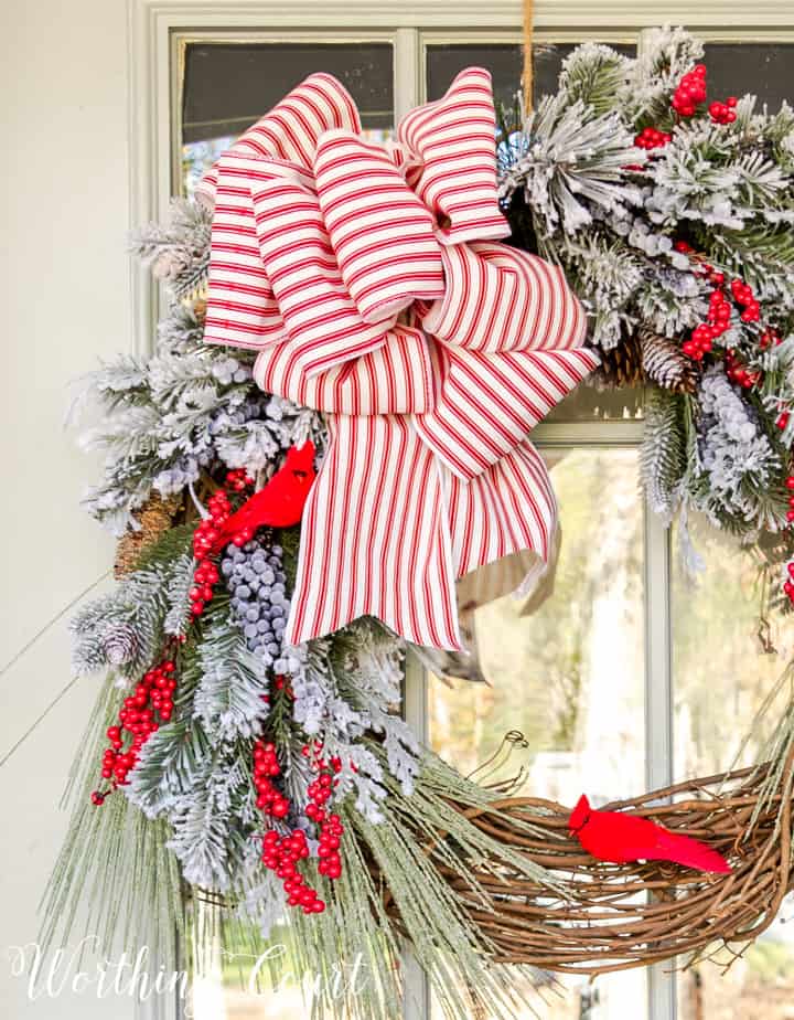 Christmas wreath with faux greenery, cardinals and red and white bow
