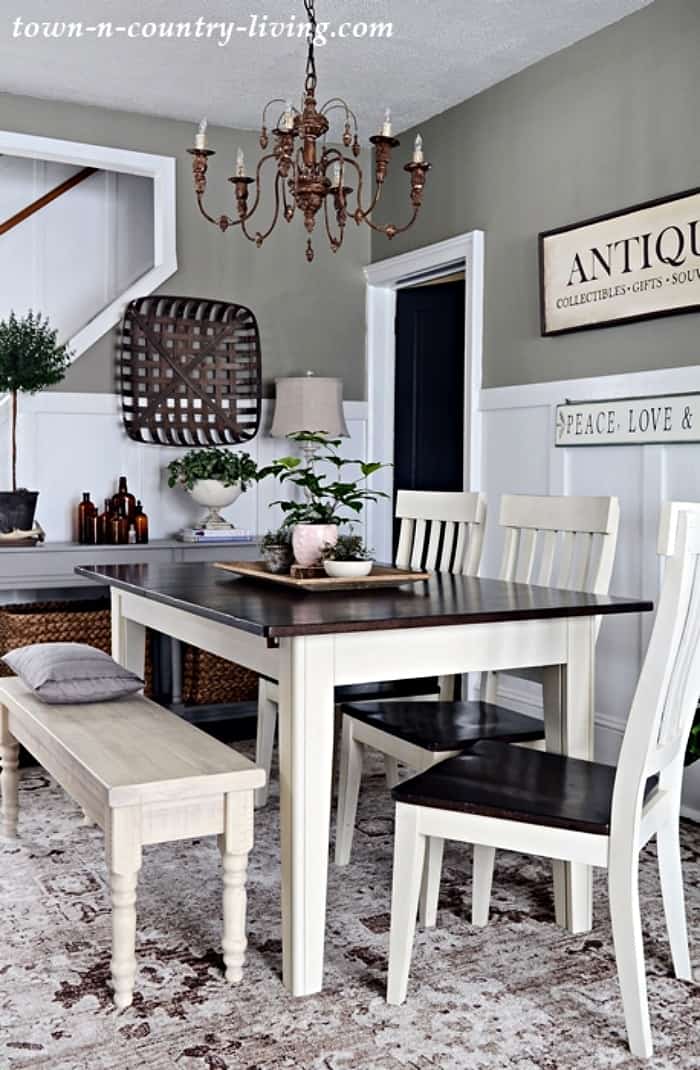 dining room table with wood top, white legs with white chairs and bench