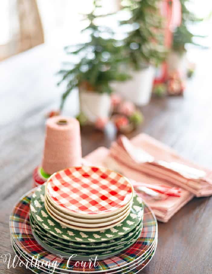 table with stack of various Christmas dishes on one end