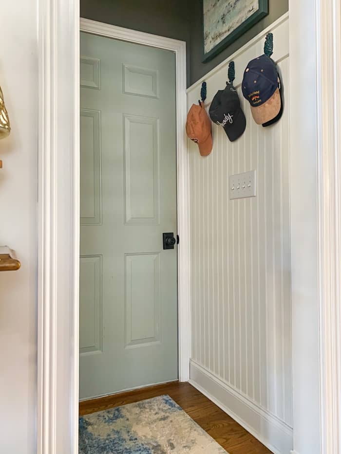 hallway with white walls and blue door