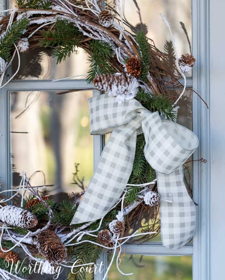 gray and white checked ribbon bow on a grapevine wreath