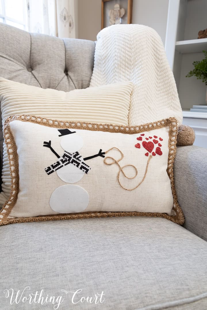 pillow with snowman and red hearts in a gray chair