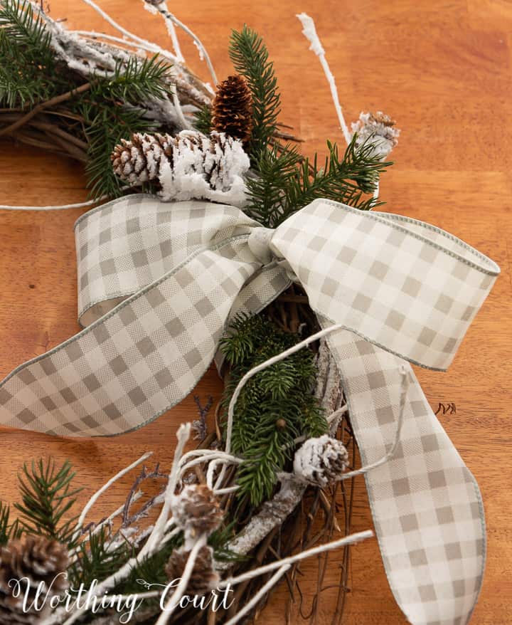 closeup of a gray and white checked bow on a wreath