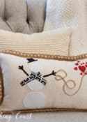 pillow with snowman and red hearts in a gray chair