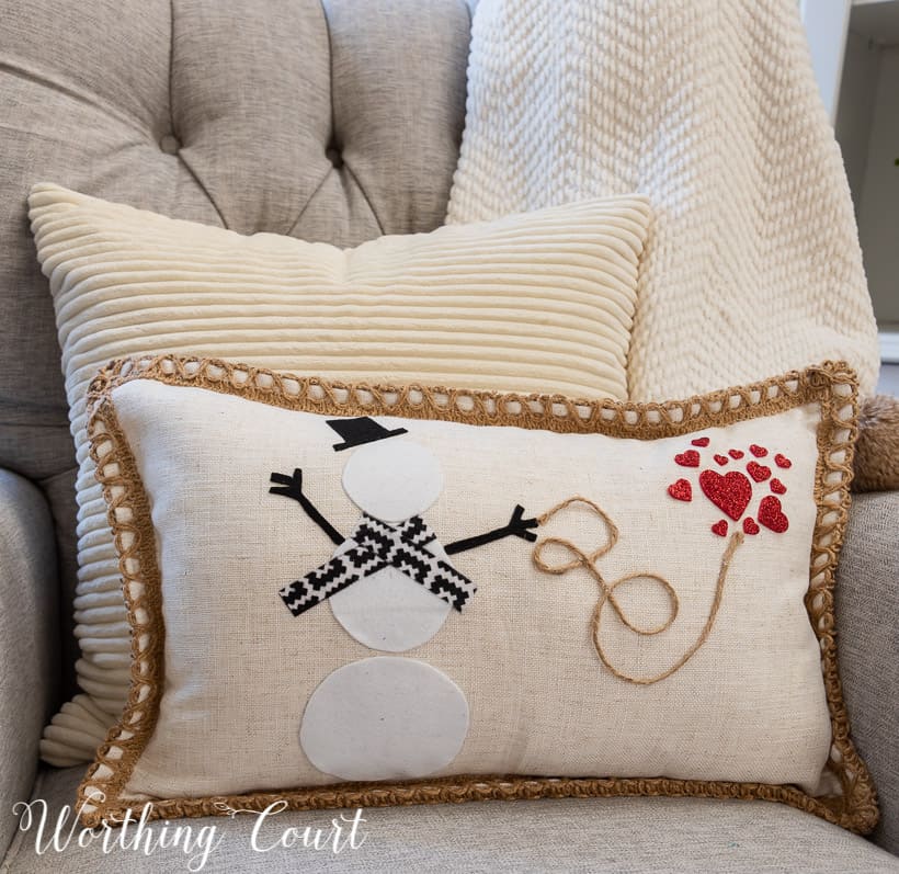 pillow with snowman and red hearts in a gray chair