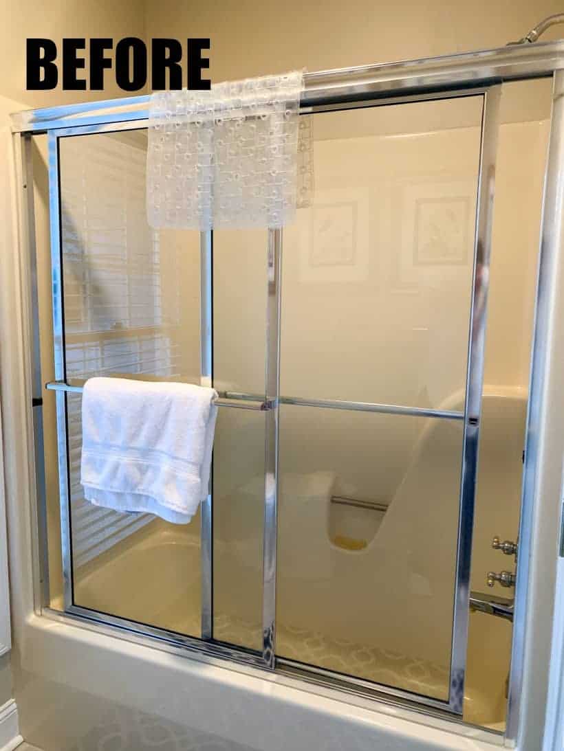 bathtub with glass shower doors