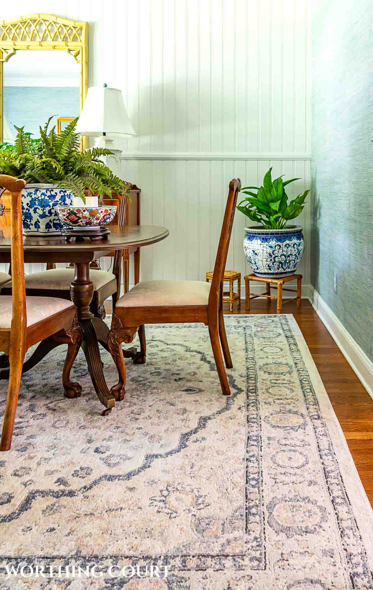 dining table and chairs on a beige and blue area rug