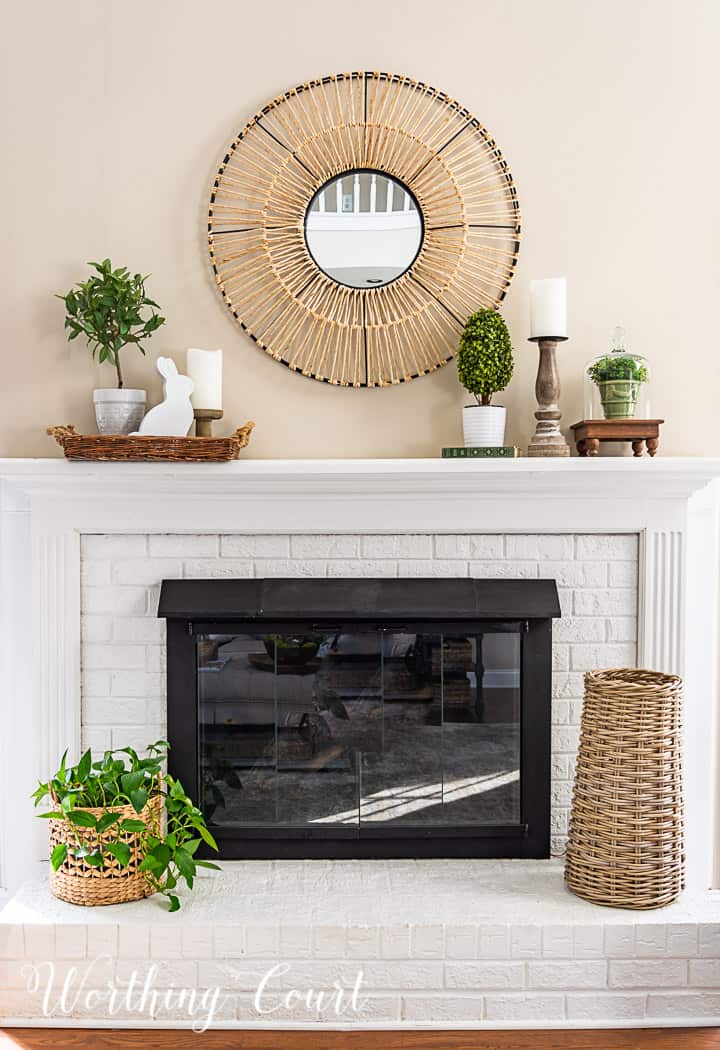 white fireplace with spring decorations on the mantle