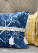 portion of a blue and white and yellow and white pillow in a gray chair