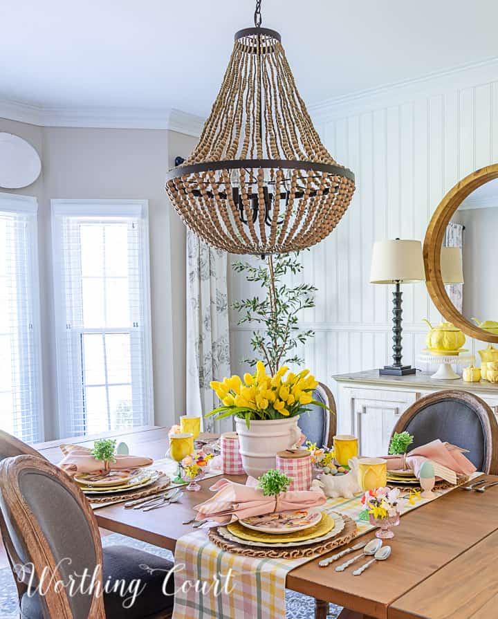 Easter tablescape using yellow dishes and faux flowers