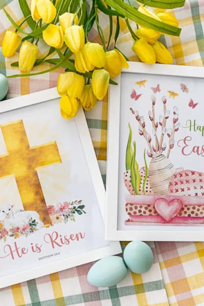 pair of framed Easter printables lying on a plaid piece of fabric