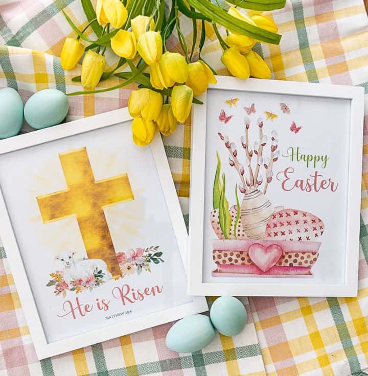 pair of framed Easter printables lying on a plaid piece of fabric