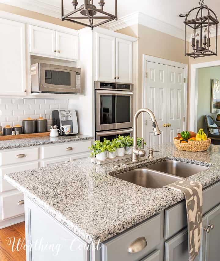 view of kitchen with white cabinets and gray island