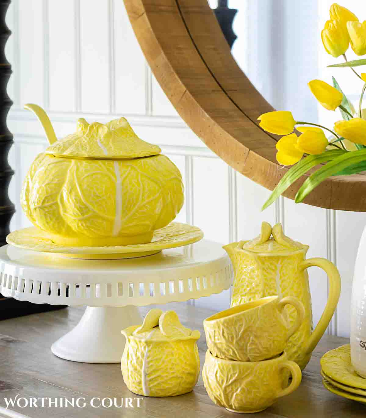 Yellow cabbage ware dishes on a white sideboard