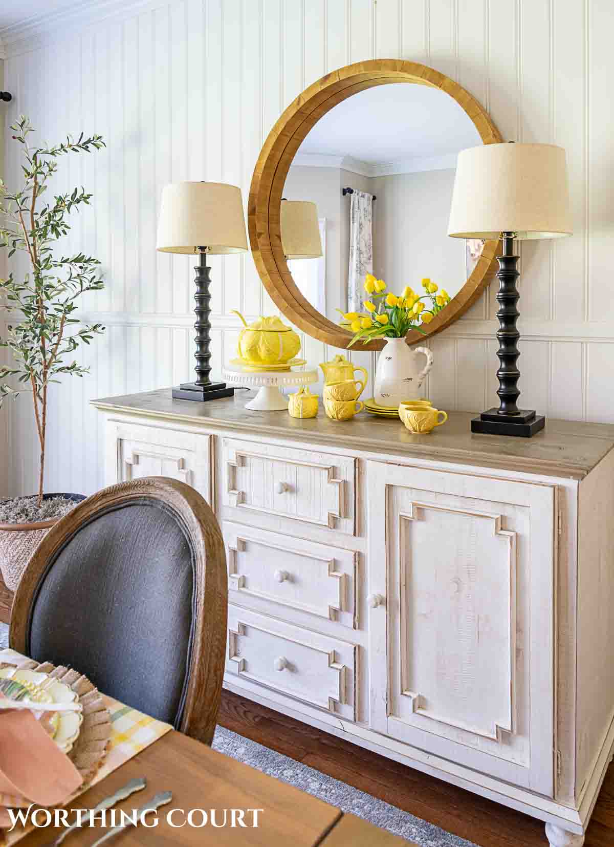 Yellow cabbage ware dishes on a white sideboard