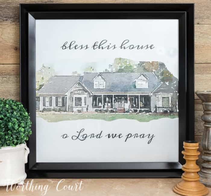 watercolor image on gray house in a black frame