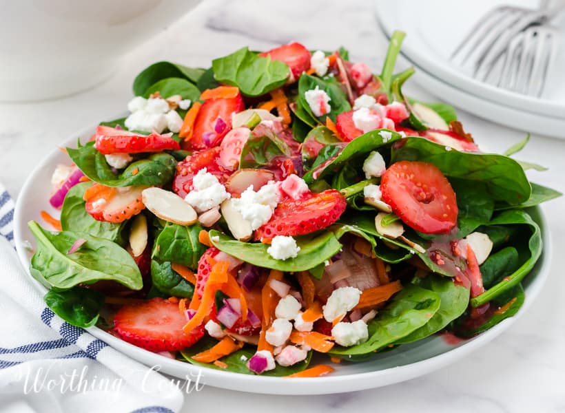 strawberry spinach salad in white bowls