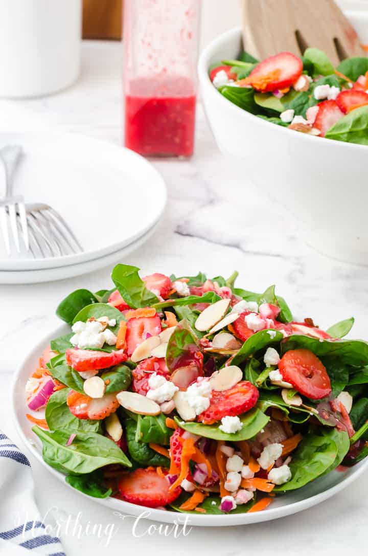 strawberry spinach salad in white bowls