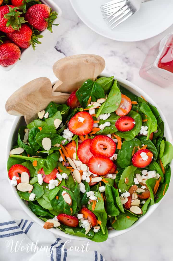 strawberry spinach salad in white bowls