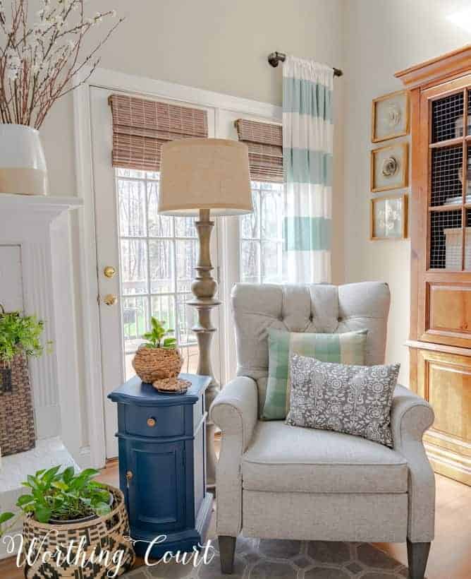 gray recliner in front of French doors with blue and white draperies