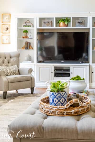 white entertainment center, chair and coffee table in a family room