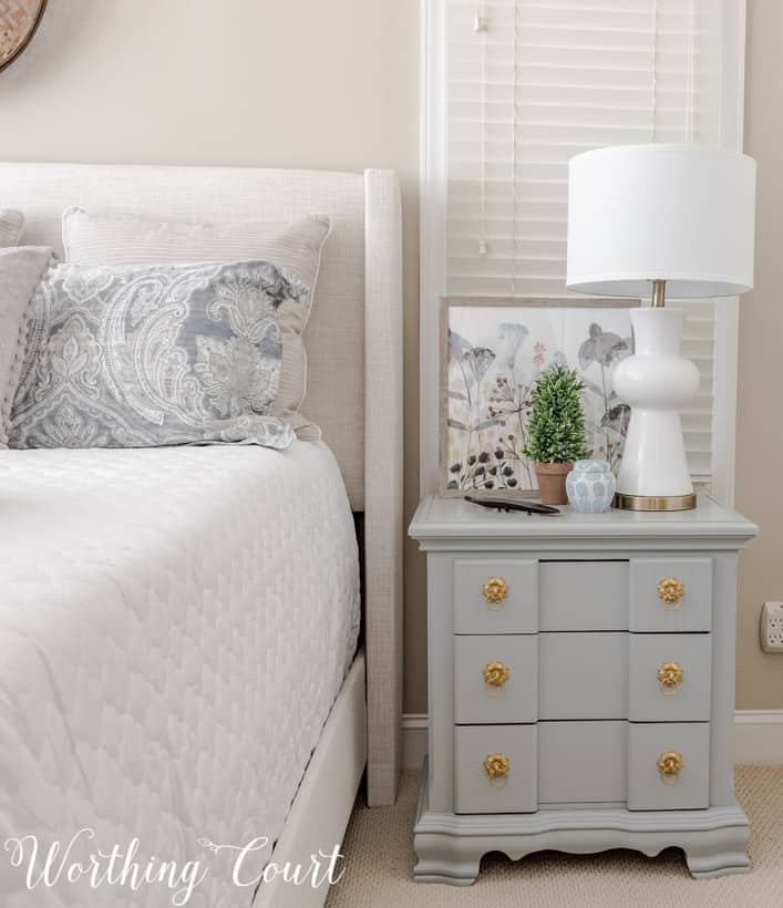 light gray nightstand with a white lamp