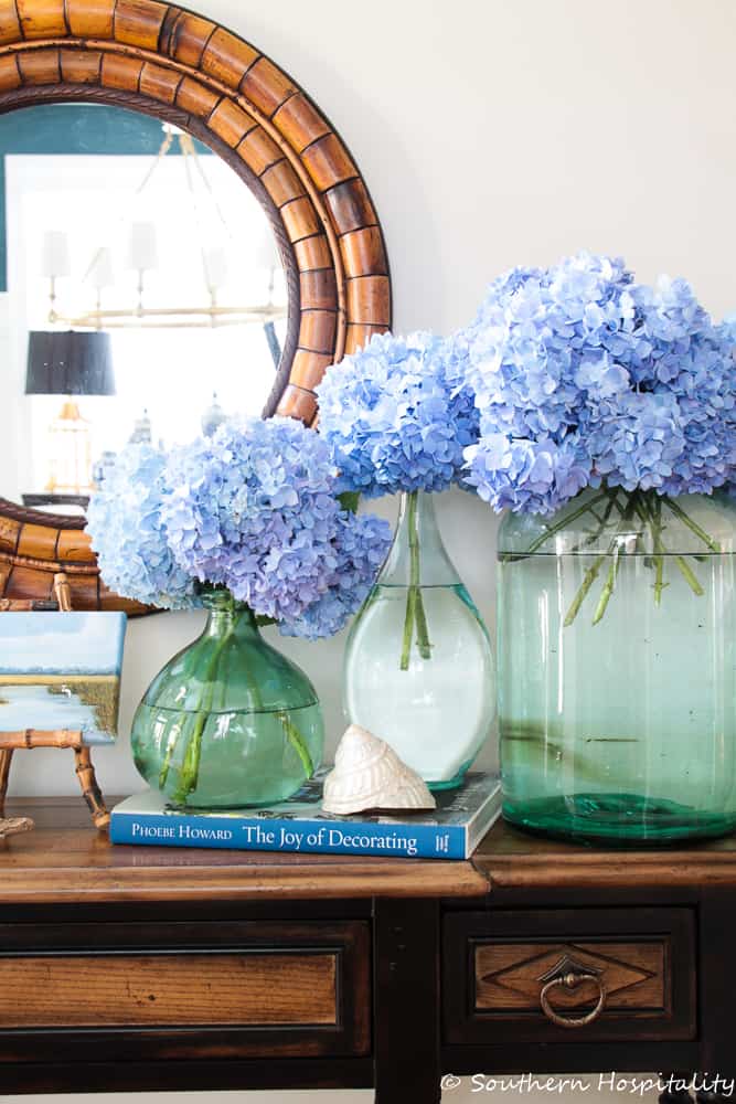 vases filled with blue hydrangea stems