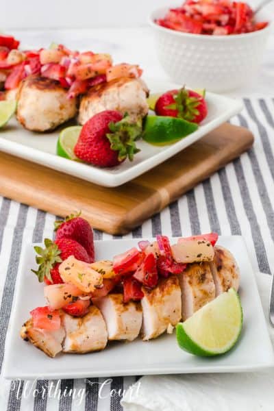 sliced grilled chicken breast topped with strawberry and pineapple salsa