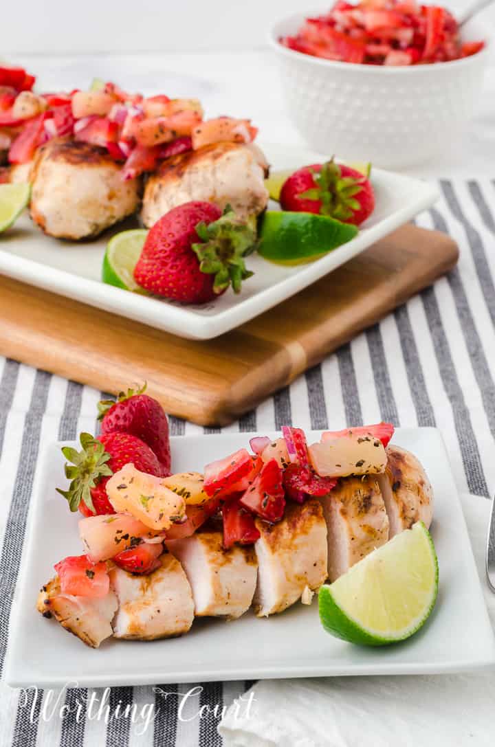 sliced grilled chicken breast topped with strawberry and pineapple salsa
