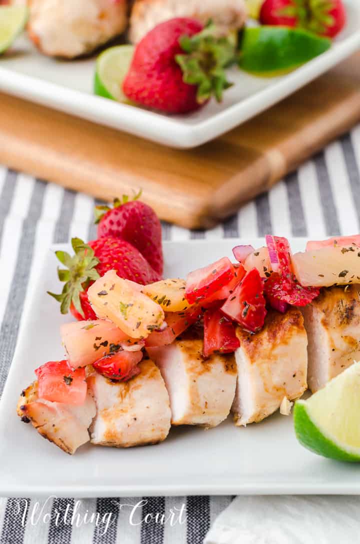 sliced grilled chicken breast topped with strawberry and pineapple salsa