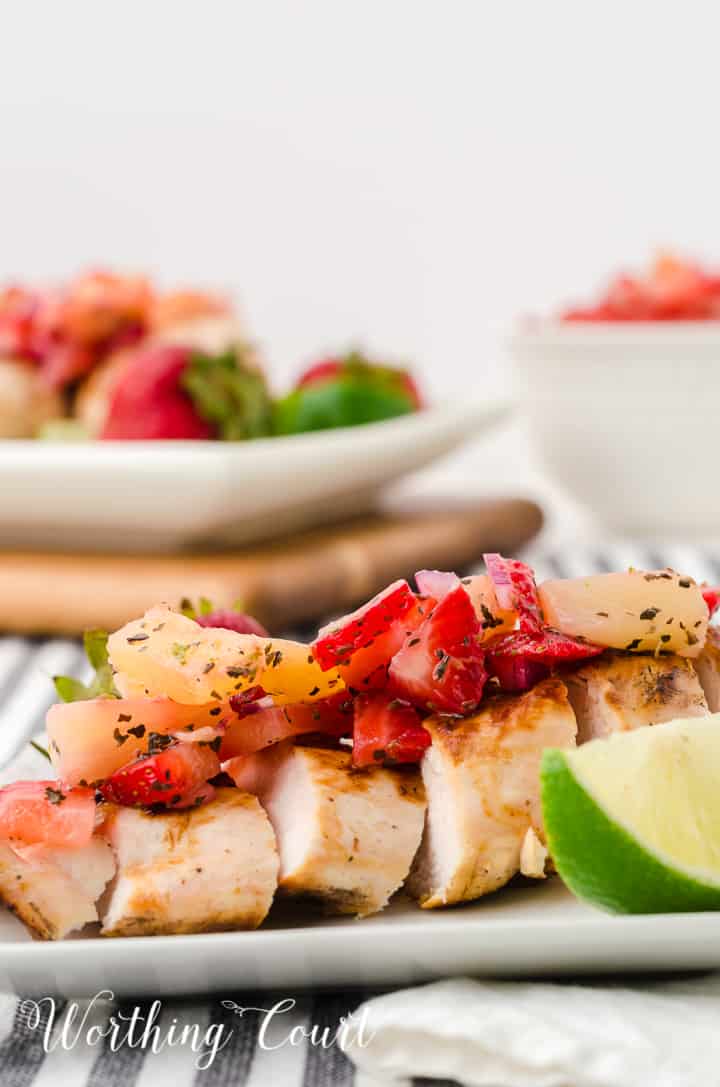 sliced grilled chicken breast topped with strawberry and pineapple salsa