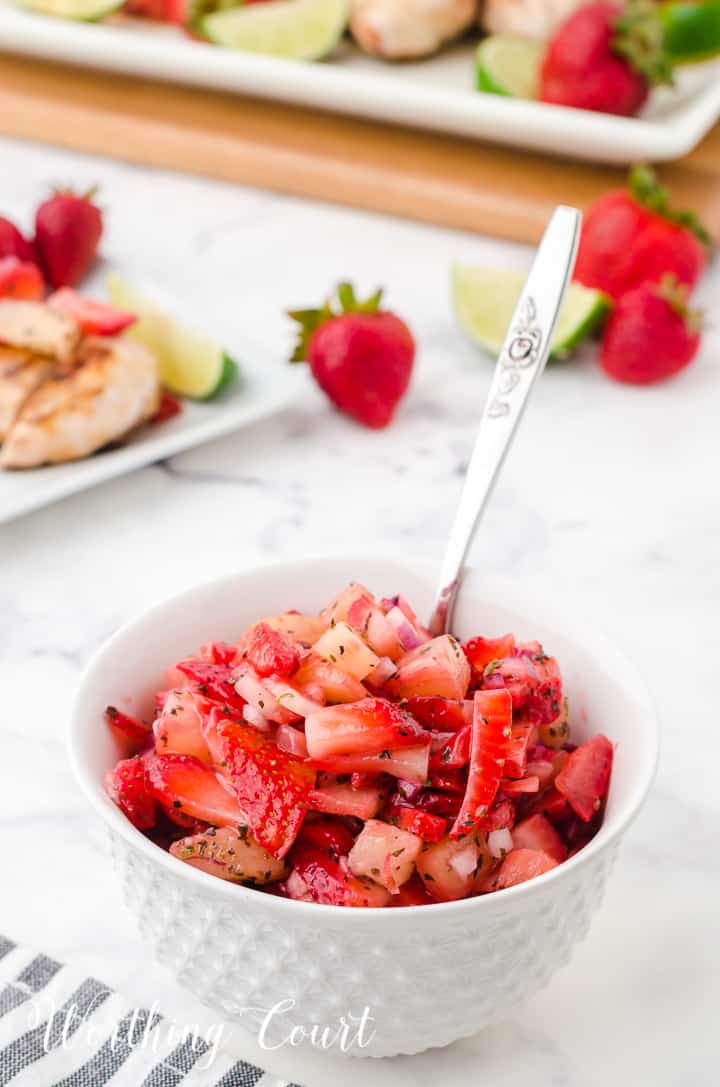 strawberry and pineapple salsa in a white bowl