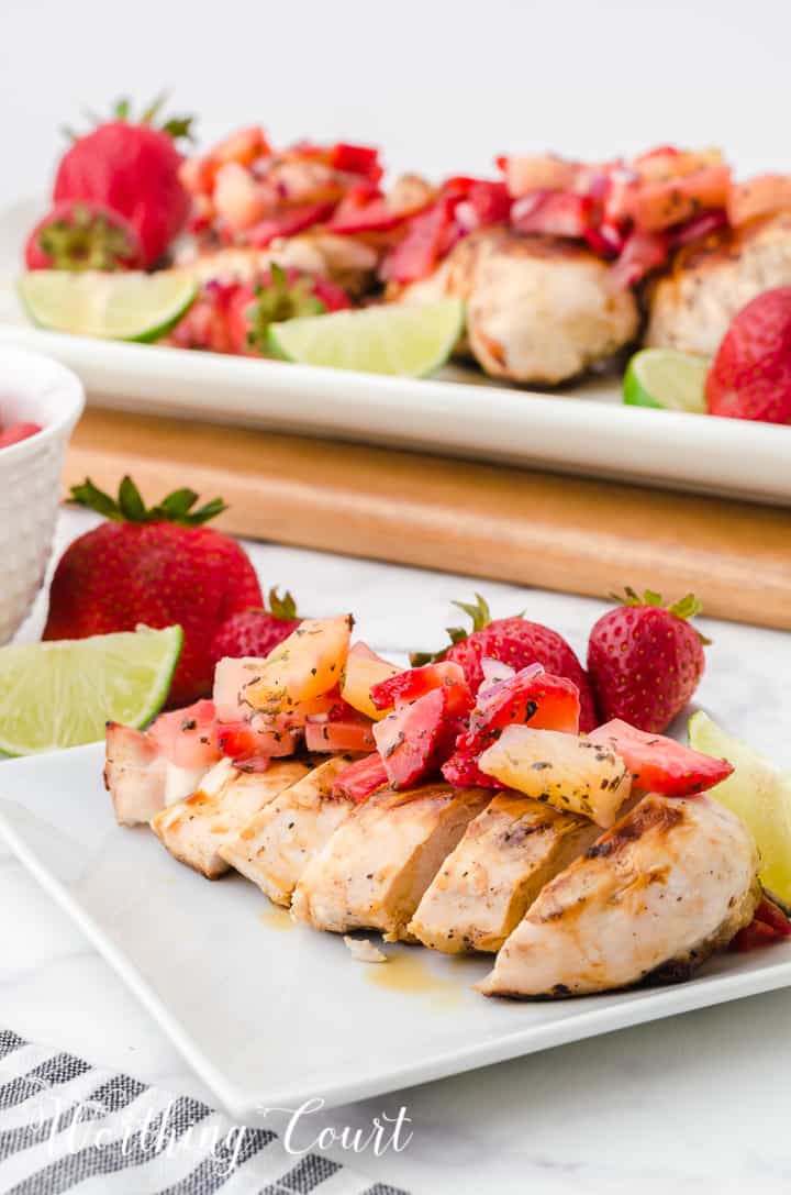 sliced grilled chicken breast topped with strawberry and pineapple salsa