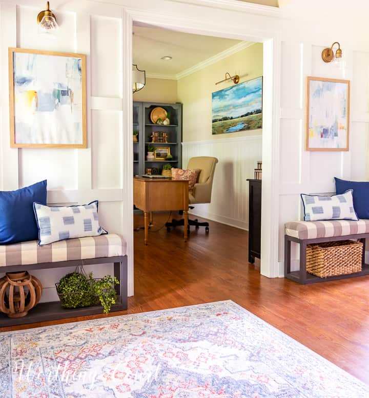 white board and batten wall and small benches flanking a door opening